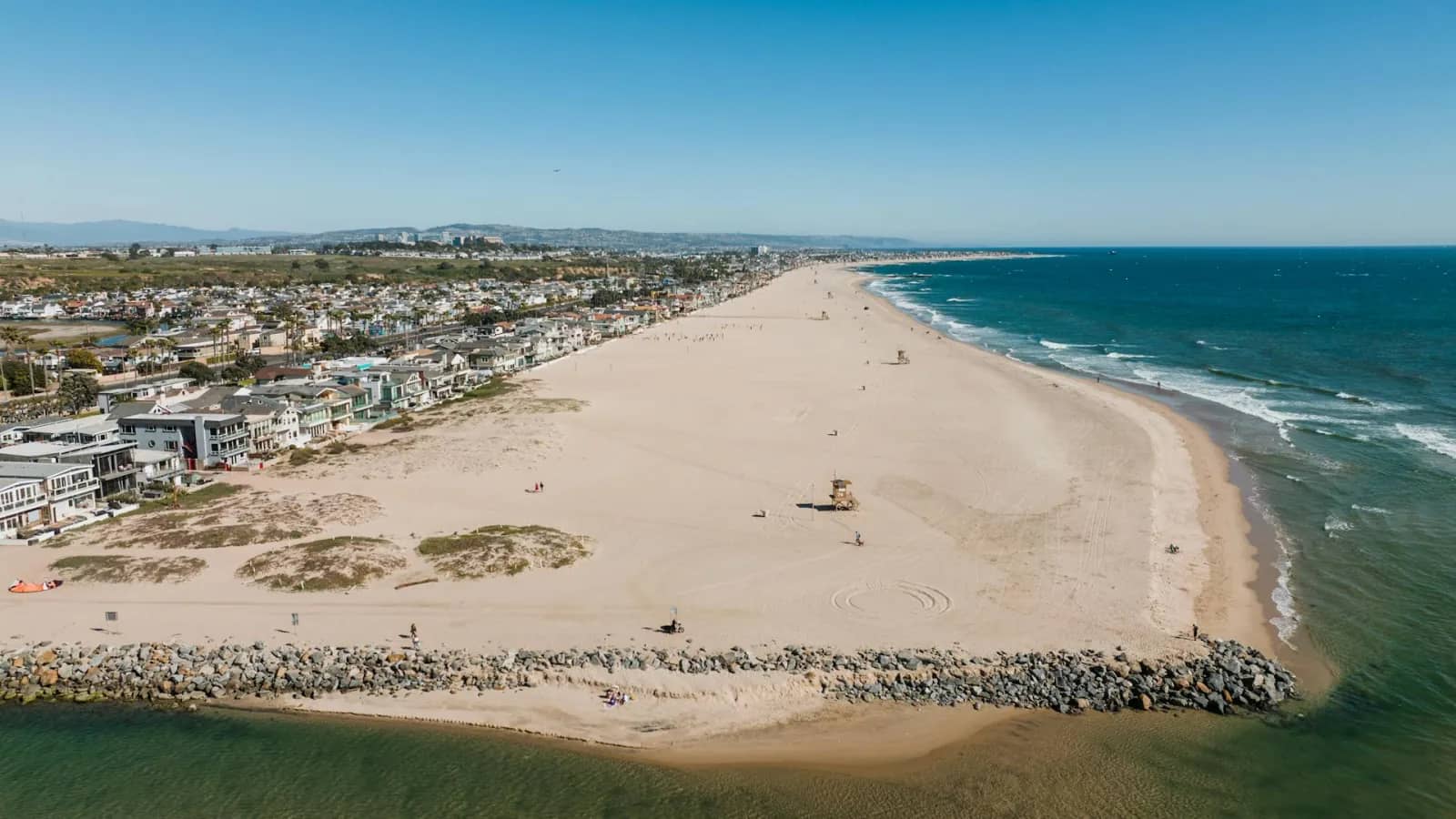 Southern California coastline with a sandy beach and seaside homes